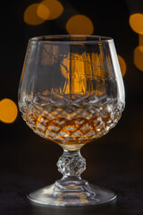 A glass of liquor in a glass with a stem. The image has a mood of relaxation and enjoyment