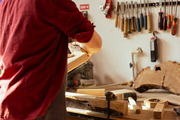 Manufacturer using sandpaper for smoothing wooden surface before polishing it, ensuring adequate...