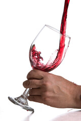 Action shot pouring red wine into a glass over a white background - 786753443