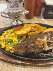 beef steak with mushroom sauce and potatoes