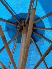 bamboo pole under blue umbrella
