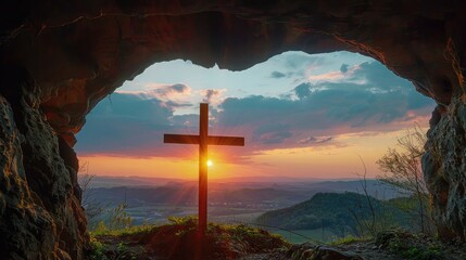Sunset view of a wooden cross from a cave