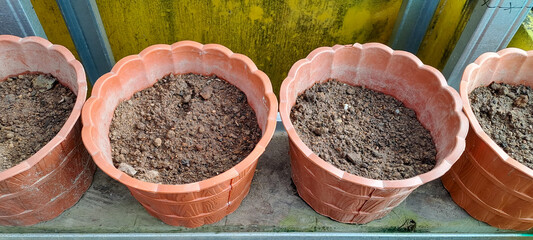 preparation for planting flower pots. Earthen pots filled with soil for planting trees in the garden