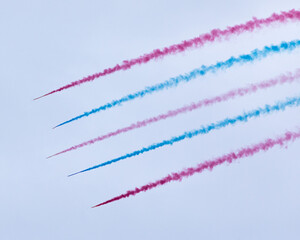 Colorful vapor trails from airplanes at an air show