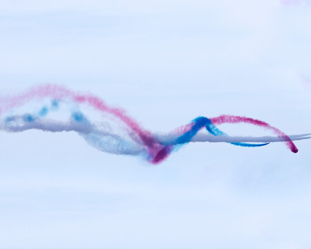 Colorful vapor trails from airplanes at an air show crossing