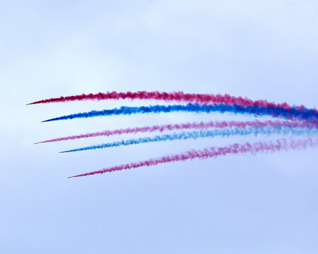 Colorful vapor trails from airplanes at an air show