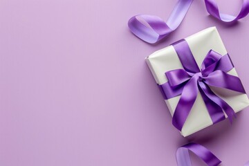 A gift box with a purple ribbon on a pastel lavender background, viewed from the top.