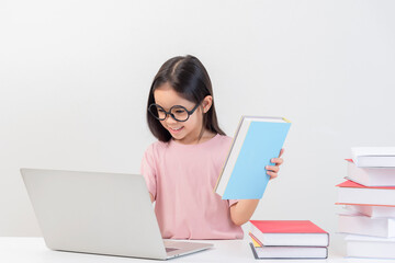 a student on the table and laptop among a large number of books