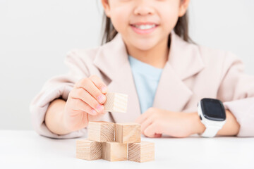 little business girlplacing wooden blocks
