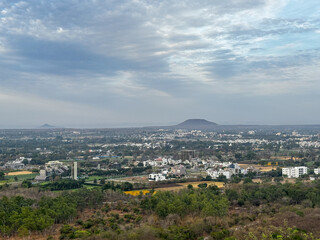 A city with a mountain in the background at Ralamandal, Indore, India.