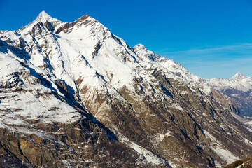 View of the picturesque mountain peaks in winter, located near the popular resort of Zermatt,...