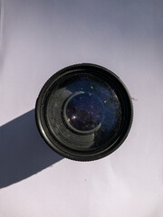 camera lens with fungus in the front element on a white background with direct natural lighting, broken lens, fungus lens, optics