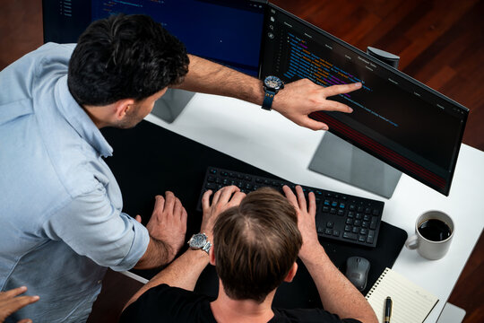 IT developers discussing online software development information on pc screen, creating program coding for latest version application on website. Concept of brainstorming firmware updated. Sellable.