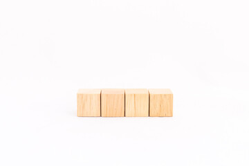 Four blank wooden cubes isolated on white background. Blank space for text.
