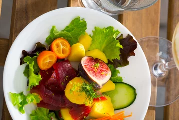 Fotobehang Appetizing salad with fresh tuna, mango, zucchini and lettuce © JackF