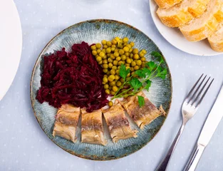 Foto op Canvas Service plate containing cold bonito with grated beetroot and green peas with necessary table laying © JackF