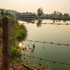 Fish farming ponds in a village near Chiang Saen, Thailand, sustain local livelihoods, fostering economic resilience and preserving traditional practices amidst picturesque rural landscapes.