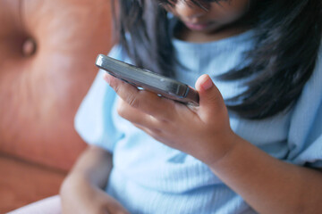 Child girl watching cartoon on smart phone 