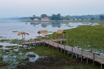 Chiang Saen Lake's Bamboo Jetty: Serene bamboo structure extending over tranquil waters, a picturesque spot for relaxation