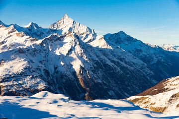 View of the picturesque mountain peaks in winter, located near the popular resort of Zermatt,...