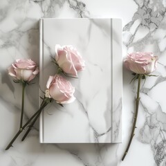 Elegant pink roses on a marble background with a blank book