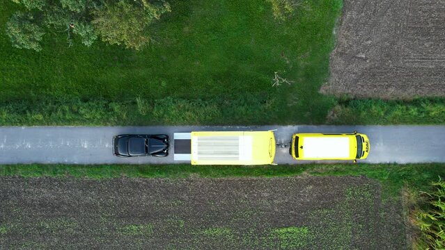 Black vintage car drives into a trailer. Ready for transport.