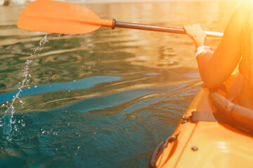 Kayak paddle sea vacation. Person paddles with orange paddle oar on kayak in sea. Leisure active...