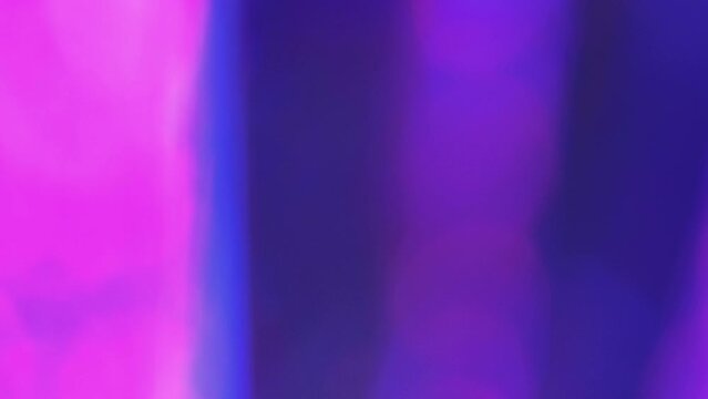 Bokeh lights. Abstract defocused glow. Party illumination. Iridescent festive spots on colorful beams glass prism refraction effect background.