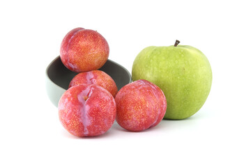 Red plums and green apple isolated on white background