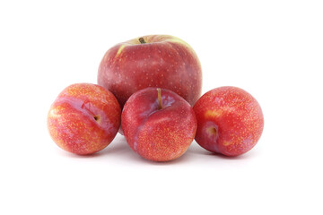 Crimson plums and red apple isolated on white