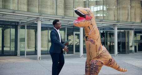Dinosaur, handshake and person in a costume with businessman in a city for welcome, partnership or intro. B2b, networking or African event host with museum curator in T rex suit for history promotion