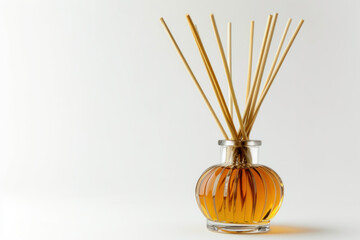 Aromatic Reed Diffuser with Golden Liquid in a Transparent Glass Vase Against a Soft Background