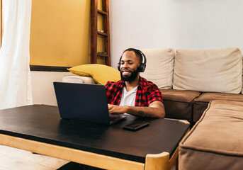 Black man teleworking with laptop from home