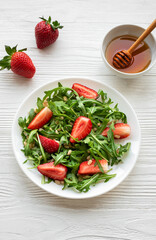 Fresh Strawberry Arugula Salad With Pine Nuts Served on a Bright Day