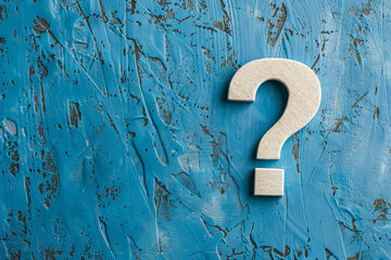 A white question mark is on a blue wall - obrazy, fototapety, plakaty