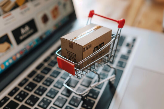 A laptop screen shows a box on a shopping cart