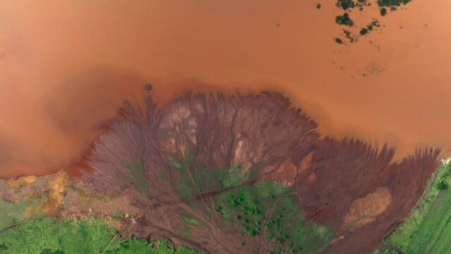 Drone flying above an muddy river delta in africa
