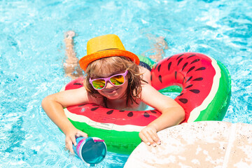 Kid in swimming pool, relax swim on inflatable ring and has fun in water on summer vacation. Summer swimming and relax, swim on ring in pool, poolside. - 786842675