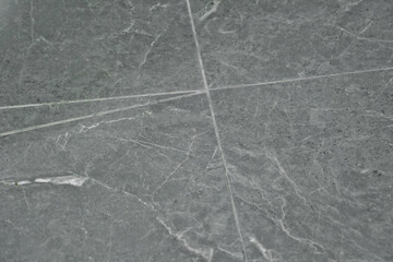 Interior tile with white cracks on gray tile