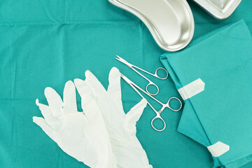 Surgical set and medical equipment on green surgical tray inside operating room.Sterile surgical...