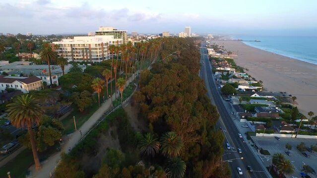 Aerial Forward Beautiful View Of Residential Buildings On Hill By Cars Moving On Road Near Beach - Santa Monica, California