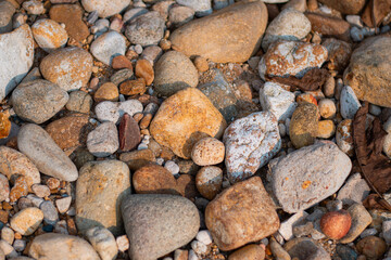 Stone wall background, Different color beach stones background.