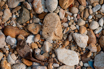 Stone wall background, Different color beach stones background.
