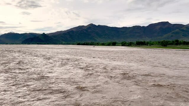 Flash flooding in river swat due to heavy rains in April. Climate change concept.