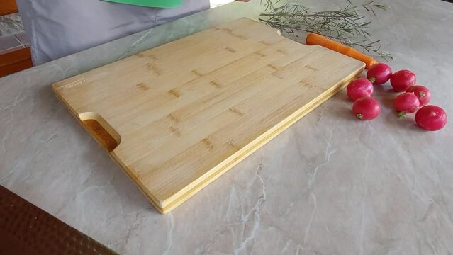 Slicing Fresh Rosemary on wooden board with Japanese ryukiri nikiri knife