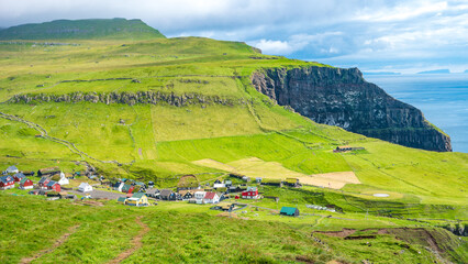 Mykines, Faroe Islands. Panoramic view of Mykines island village, bird watching destination for puffins. Traditional houses with turf roofs