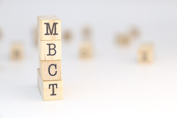 Mindfulness Based Cognitive Therapy MBCT written on wooden cubes