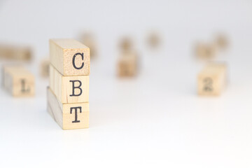 Abbreviation CBT Cognitive behavioral therapy on cube blocks. psychological problem concept.