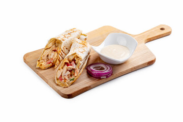 Doner kebab with chicken is a dish of grilled chicken and fresh vegetables wrapped in pita bread on a wooden board. Isolated White background