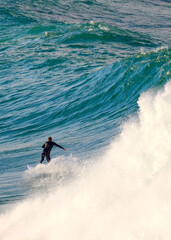 Surfing a large wave at Dee Why Beach in Sydney, Australia